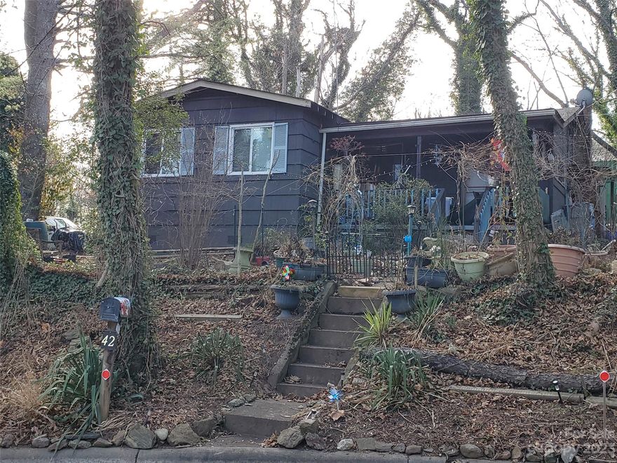 A gardener's delight with private backyard. This fixer upper offers lots of potential. Great
location; ½ mile to Hillman Beer and Moe’s Barbeque, less than a mile to Biltmore Village.