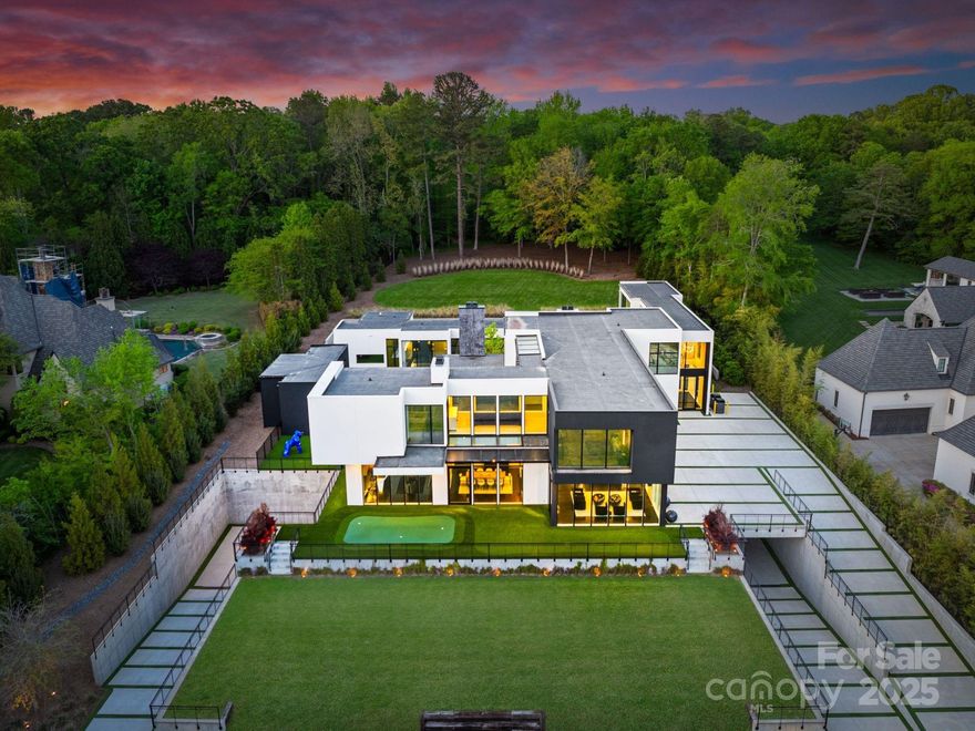Situated on over 1.75 acres in SouthPark’s sought after Carmel Park neighborhood. This modern residence offers unmatched durability, bold design and refined elegance. A floating concrete motor court makes a dramatic first impression, setting the tone for the home’s architectural presence. Inside, expansive open living spaces are framed by clean lines and walls of glass, creating a fluid transition from indoors to outdoors with views of the infinity-edge pool, sophisticated gardens, courtyard and expansive lawn. Secluded and secured by 2 gated entrances, this home also has 2 detached living spaces on the property which can used for guest suite, studio, office, etc. State of the art HVAC and Audio/Video and a 2,800 SF subterranean garage This exceptional residence was designed by Greg Perry Design and built by the Thompson Building Group.