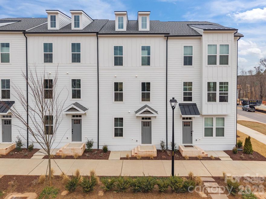 Welcome to The River District—a true master-planned community where lifestyle and location come together beautifully.

This beautifully appointed Landon three-story townhome offers a thoughtfully designed layout with a first-floor guest bedroom and full bath—perfect for visitors, multigenerational living, or a private home office.

The second level showcases a gourmet kitchen featuring quartz countertops, a built-in oven and microwave, electric cooktop, and soft-close cabinetry. The open-concept dining and living areas create an inviting space ideal for entertaining, while sliding glass doors lead to your private balcony—perfect for relaxing or enjoying your morning coffee.

Upstairs, you’ll find two beautiful owner’s retreats, each offering a bright, airy bedroom and a spa-inspired bath for ultimate comfort and privacy. A conveniently located laundry area completes the upper level.

This home is filled with beautifully curated interior finishes, individually hand-selected by our professional design team, creating a cohesive and elevated aesthetic throughout.

Location is everything—and at The River District, you’re truly minutes from it all. Planned community amenities include a resort-style pool, clubhouse with fitness center, tennis and pickleball courts, parks, scenic trails, a working two-acre farm with an on-site farmer, and a riverfront amphitheater.

Experience vibrant, connected living in one of the area’s most exciting communities.