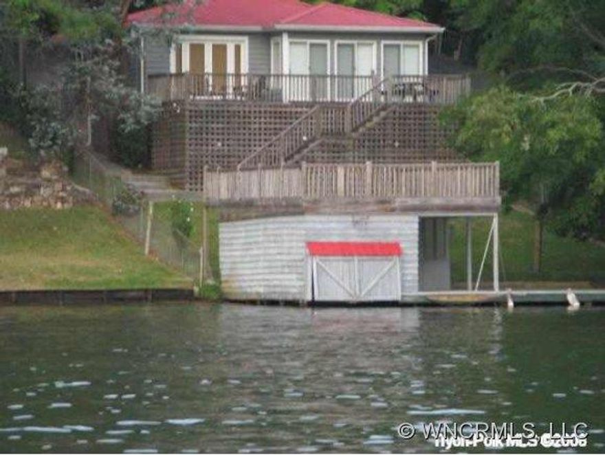 Newly remodeled  lakefront cabin with wood floors, wood walls and wood ceilings. Great views-over 700 sq ft of decks, 400 sq ft boathouse with screened porch-easy walk-swim area.