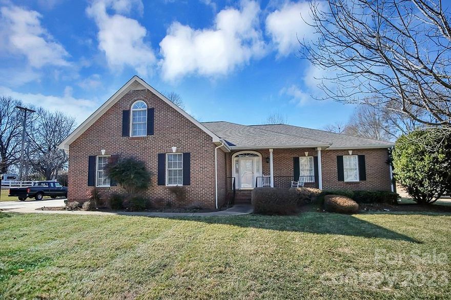 Exquisite brick home in desirable Kings Mountain Country Club area. This 4 bedroom, 3 full-bathroom home sits on a half acre lot This home boasts hardwood floors w/an inviting living room w/a gas-log fireplace & vaulted ceiling. The kitchen, adorned with solid surface countertops, features a gas cooktop, wall oven, dishwasher & refrigerator. Enjoy meals in the dining room or unwind in the sunporch flooded with natural light. The main level hosts three bedrooms, including the primary suite with a walk-in closet & a spa-like bathroom featuring a dual vanity, standup shower & a relaxing garden tub. Ascend to the upper level, where a versatile bedroom/bonus area awaits with its full bathroom & walk-in closet. Convenience meets style with a two-stall garage providing storage space & a sizable outbuilding for additional versatility. Convenient location just minutes from I-85 w/approximately 30 minute drive to Charlotte-Douglas Airport along with restaurants, parks & more at your fingertips!