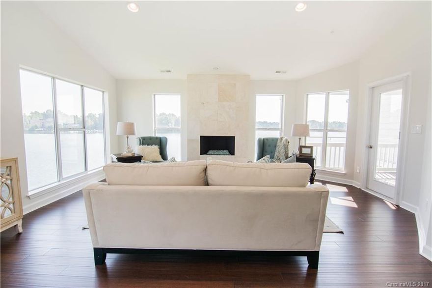 You won't believe the views on this exquisitely remodeled corner unit. Enjoy THE LIFE while only 30min from uptown Charlotte. Luxurious solid wood flooring, marble baths, new custom cabinets in kitchen + baths with quartzite counters, mother-of-pearl backsplash, SS appliances, wine chiller, new AC and designer lighting are professionally coordinated to create comfort and luxury. Enjoy pool, boating, tennis, walking trails and the property waterfront restaurants as part of your lake living.