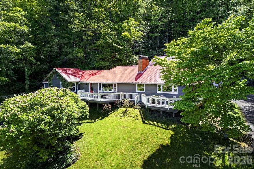 OPEN HOUSE: Sunday, May 3 from Noon to 2pm

Some homes are special—you know it the moment you walk through the door. This is one of those homes.

Mountain views, timeless charm, and thoughtful design come together at 75 Old Lakey Gap Road in the heart of Black Mountain. Perched gently on a hill, this 4-bedroom, 3-bath home captures sweeping views of the Craggy Mountains and beyond, offering a peaceful retreat just minutes from town.

From the moment you arrive via the circular driveway, the striking red roof and welcoming red doors set the tone—inviting, distinctive, and full of character. Inside, the dining room features a beautiful brick floor, adding warmth and architectural interest that carries throughout the home. The inviting living area centers around a large fireplace and a stunning picture window that frames the mountain views—filling the space with natural light and bringing the outdoors in.

Designed for easy one-level living, the main floor includes a spacious primary suite with direct access to the deck—an ideal spot to enjoy morning coffee while taking in the mountain views and blooming hydrangeas. A cozy loft offers a flexible retreat for rainy afternoons, reading, or additional sleeping space.

The home also offers excellent guest accommodations, with a separate living area that can function as a private suite—complete with bedroom, bath, and lounge space.

A durable metal roof provides peace of mind, while the expansive deck creates seamless indoor-outdoor living, perfectly positioned to soak in the beauty of the surrounding mountains.

This is mountain living at its finest—full of charm, comfort, and unforgettable views.