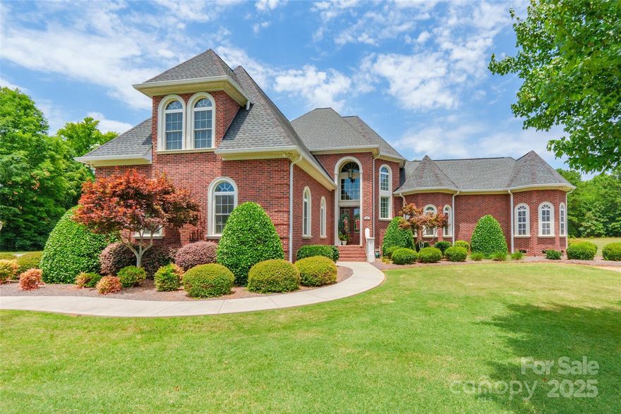 Experience timeless elegance in this castle-inspired estate set on over 2.5 acres of beautifully landscaped land. Step into a grand foyer where rich hardwood floors lead through expansive living areas filled with natural light. This spacious home features 4 bedrooms and 3.5 baths, including a luxurious main-level primary suite with a spa-like ensuite offering a step-up garden tub, heated floors, and a large walk-in closet. Outside, enjoy a covered porch and upper deck overlooking a fenced inground pool surrounded by palm trees, perfect for relaxing or entertaining. A second living quarters built in 2008 with a newer HVAC system includes a bedroom, full bath, kitchen, bonus room, and a two-car garage, ideal for guests or extended stays. Every detail of this home has been thoughtfully crafted to create a private sanctuary blending comfort, elegance, and versatility in a truly unique setting.