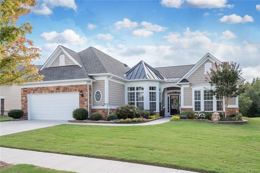 Beautiful Cumberland Hall on private lot w/ wooded lake views. Open layout w/ crown molding & hardwoods; kitchen features granite counter-tops, gas cook top, tile back splash, SS appliances, center island, under cabinet lighting, & cabinet roll-outs. Upgrades include mud sink, tank-less water heater, garage storage lift & upgraded aluminum pull down stairs for attic access. Gorgeous 3 season room, travertine tile patio, landscaping w/ extended flower beds & irrigation system. 55+ Community.