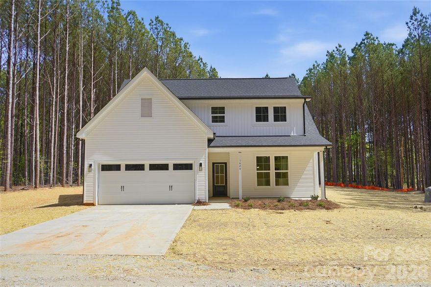 Welcome to this thoughtfully designed new construction home nestled on 1.24 private, wooded acres in York, SC. Blending transitional style with custom-quality finishes, this home offers an efficient and inviting layout perfect for modern living. A spacious front porch sets the tone for the comfort and charm found throughout.

The main level features an open-concept design with 9-foot ceilings that enhance the sense of space, filled with natural light and complemented by recessed lighting throughout. Durable rigid core LVP flooring flows seamlessly through the main living areas. The living room is anchored by a cozy electric fireplace, while the kitchen impresses with a large island, shaker-style cabinetry, quartz countertops, and brand-new stainless steel appliances—including a refrigerator. Sliding doors open to a covered back porch complete with a ceiling fan, overlooking a serene, tree-lined backyard.

Convenience meets comfort in the first-floor owner’s suite, featuring a walk-in closet and a well-appointed bath with dual vanities and a tile shower surround. A laundry room with a utility sink is also located on the main level for added ease.

Upstairs, you’ll find three spacious bedrooms, a full bath, and a versatile loft area—perfect for a home office, playroom, or additional living space.

This home offers the perfect balance of privacy, style, and functionality—an ideal retreat just waiting for you to make it your own.