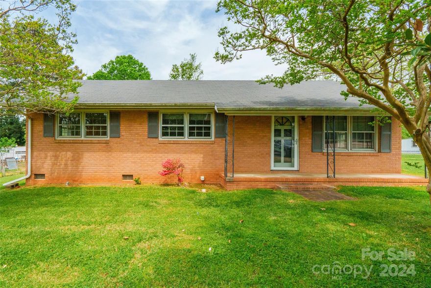 Step into this inviting 3 bedroom, 2 bathroom brick ranch home welcomed by a covered front porch framed by a stunning Crepe Myrtle and Magnolia tree. Inside, original hardwoods await in the living room and can be found under the carpets, offering the opportunity to restore and enhance the home's character. A spacious utility room adds practicality to daily living. Outside, the large flat fenced backyard provides ample space for recreation and relaxation, complemented by a shed with power for added convenience. Ready for your personal touch, this home offers endless possibilities to make it your own. Situated in a central Rock Hill location, close to downtown, Winthrop College, hospitals, shopping, and dining, this property presents an ideal blend of convenience and potential.