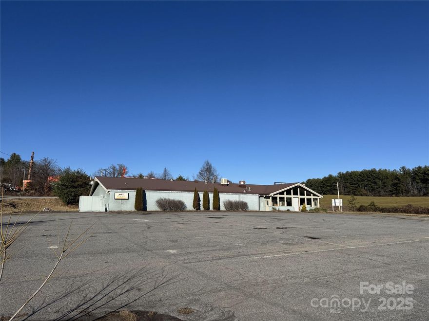 4.2 acres +/- located right at the on-ramp to I-26 at the Mars Hill exit within a 1 minute drive from Mars Hill College and twenty minutes from downtown Asheville.  Great redevelopment possibilities with excellent interstate frontage and visibility. The original Western Steer Steakhouse building contains 8900 sf +/- and building can be repurposed as it has vaulted ceilings and exposed beams.  There is another convenience store building that isn't given any additional value. Potential uses include multi-family, medical, retail, and light industrial. Topography is gentle with adequate parking for most uses.
