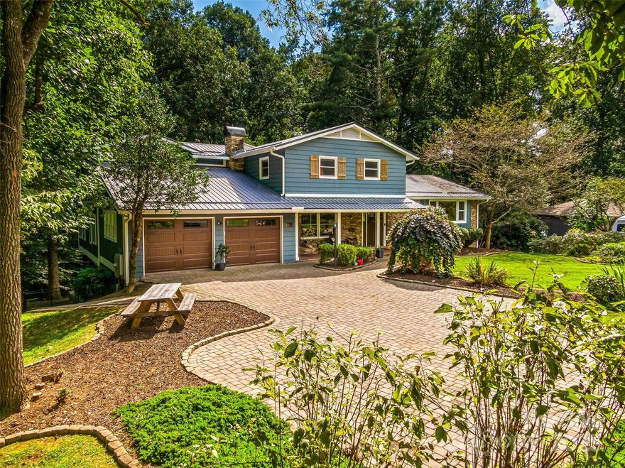 Welcome to 135 Dogwood Drive, an updated home in one of Brevard’s most convenient and sought-after locations—just a short, easy walk to downtown Brevard and only steps from Silvermont Park. This property combines modern renovations, flexible living spaces, and outdoor features that set it apart from anything else on the market.
Inside, the home shines with a completely redesigned and renovated kitchen and main-level living space. Custom cabinetry, upgraded appliances, sleek countertops, a large island, and a butler’s pantry create the perfect gathering hub. The open floor plan flows naturally, framed by large windows for abundant light. A True undercounter beverage center adds convenience right in the kitchen. The large primary suite is a private retreat with its own screened-in porch and a bathroom featuring heated tile floors, a garden bathtub, and a walk-in shower. In total, the home provides five-plus bedrooms with multiple bonus areas, giving you flexibility for guest rooms, home offices, creative studios, media, fitness, or hobby use. On the lower level, the home transforms into an entertainer’s dream. The custom-crafted bar is a showcase of craftsmanship and design, featuring shelves built from reclaimed floor joists salvaged from an old Brevard home, cabinetry faced with reclaimed barnwood from Tennessee, and a bar top and countertops of quarter-sawn white oak. Premium appliances include a Scotsman pellet ice machine and a second True brand undercounter beverage center, ensuring the perfect setup for gatherings. Outdoor living is equally impressive. A rear deck resurfaced with new Trex composite decking provides low-maintenance space for grilling, dining, or soaking up the mountain air. The spacious fenced-in backyard offers privacy, room to play, astroturf for year-round greenery, and even a small stream along the edge of the property. It’s a rare find so close to downtown. Practical features include a large two-car garage, generous storage throughout, and a level brick paver driveway for easy year-round access. 135 Dogwood Drive blends modern updates, custom details, and a prime in-town location. Schedule your showing today!