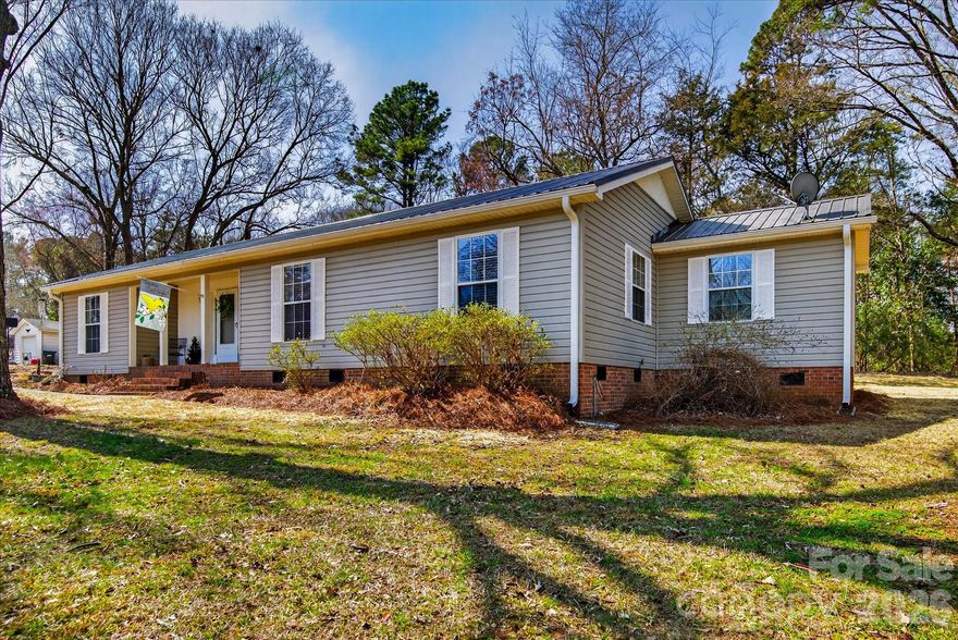 Welcome home to this adorable 1 story home with NO HOA in Indian Land, SC!  Situated on just under an acre on a quiet dead end street, this meticulously maintained and recently updated beauty has a brand new tiled shower and floor plus freshly painted cabinets in the primary bath, brand new laminate floors throughout, renovated kitchen with quartz counters and stainless appliances, new Metal Roof and gutters, encapsulated crawlspace, new water heater, and HVAC is less than 5 years old!  Step out of the backdoor into the large outdoor living space! Relax under the covered back porch with a recently built deck and enjoy a private, tree lined view where you can watch the wildlife. French drains just installed to improve drainage in the back. Spacious primary bedroom with 3 large closets and extra flex space attached that is perfect for an office, nursery, or whatever you like!  Secondary bedrooms are very roomy too! Location is phenomenal as it's just minutes to Fort Mill, Ballantyne and  all of the new conveniences in Indian Land for shopping, eating, and entertainment. More Pictures are coming soon!
