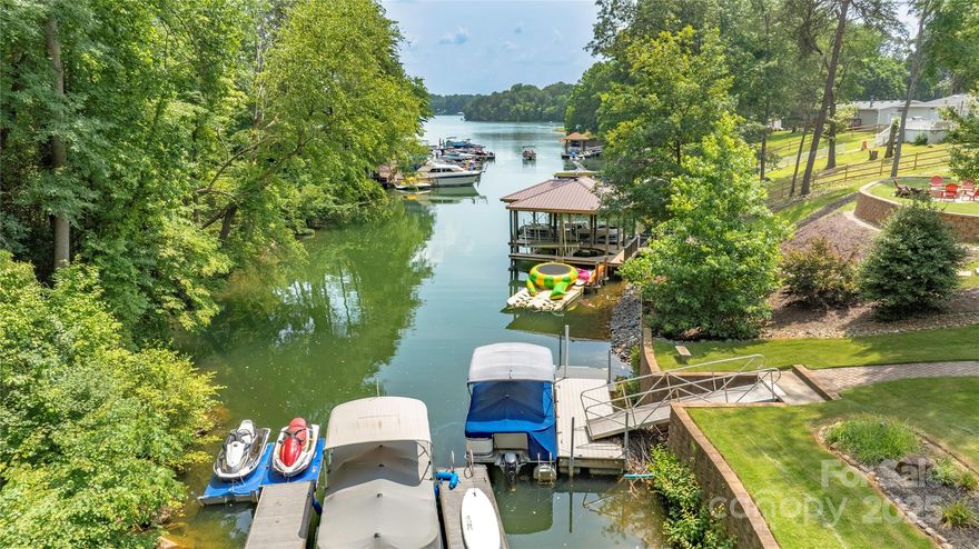This spacious, perfectly maintained, 2 story WATERFRONT home has everything you need to live on the lake!  Close everything Sherrill's Ford has to offer!  It has been used as a vacation rental and can be used as such, or make it your forever home!  Private boat slip offers easy access from the quiet cove to the main water. The cove is perfect for swimming, kayaks, paddle boards.  This 4 bedroom home, boasts a bright open floorplan for great family interaction or entertaining. The laundry closet is located in a spare bedroom which could easily be used for office space.  Downstairs you will find generous living space with separate kitchenette and bathroom that can be used as a game/entertainment room, or just another great space for movie night!  The two story back deck gives great views of the lake, with a hot tub on the lower level for privacy. Spacious oversized two car garage offers a great work space area. New HVAC installed April 2025.  Motivated seller.