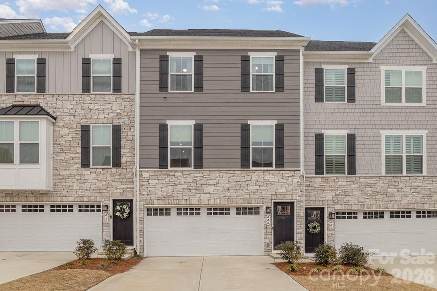 This beautiful townhome located in the award-winning Fort Mill School District is thoughtfully designed with an open concept that is perfect for entertaining. The gourmet kitchen is a chef's dream, boasting a large island that seats 4+, sleek quartz countertops, upgraded cabinetry, stainless steel appliances, and a convenient pantry. It flows into a generous dining area and a beautifully appointed living room, both with custom trim work. Step outside to the main level deck, ideal for outdoor gatherings. The luxurious primary suite upstairs features a walk-in closet and a spa-like bath with a soaker tub and oversized shower. Two additional bedrooms, a full bath, and a laundry room with custom cabinetry and a sink complete the upper level. The lower level offers an expansive family room with custom cabinetry, a full bath, and a garage with an epoxy floor and cabinetry - perfect for a lounge or home gym. Conveniently located near shopping, dining, I-77, and the amenities of Tega Cay, including a beach club, parks, walking trails, and golf courses, this townhome truly has it all!