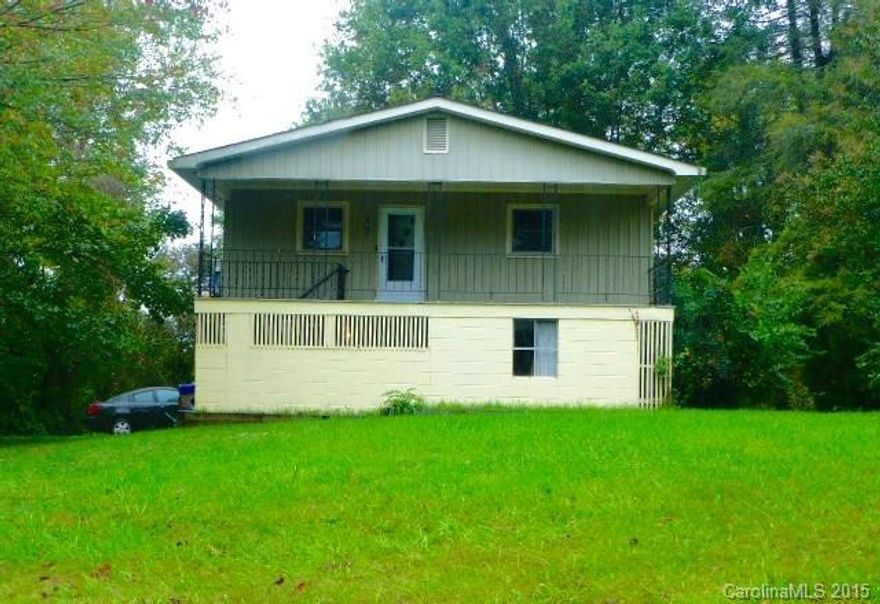 Darling bungalow with GORGEOUS hardwood floors, cool HUGE wrap around covered porch, large eat-in kitchen open to living room which has a freestanding fireplace. Awesome vintage pink & black bathroom, tilt-in vinyl windows, this home is in MOVE-IN CONDITION!  Basement w/1 car garage...was built as 2 car & door could be opened back up.  Bright separate workshop in basement too.  LARGE level yard for kids or pets.  Minutes to Blue Ridge Parkway, x-pressways, & downtown Asheville.  MUST SEE!