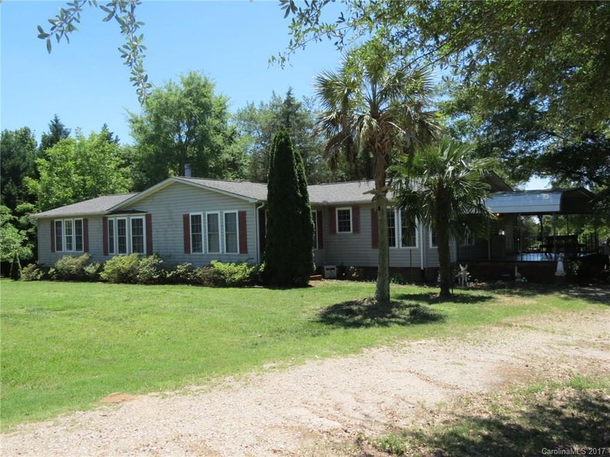 This is a one of a kind property.  When driving into the property you are welcomed with a nice driveway lined with live oaks.  The property has many different kinds of trees strategically planted.   The home is 3 bedroom 2 1/2 bath with a large living area and kitchen.  The home has a large covered side porch and a large deck on the back.  There is an equipment barn that could easy be used for animals and plenty of other outbuildings and covered sheds.  The property also touches a large pond.