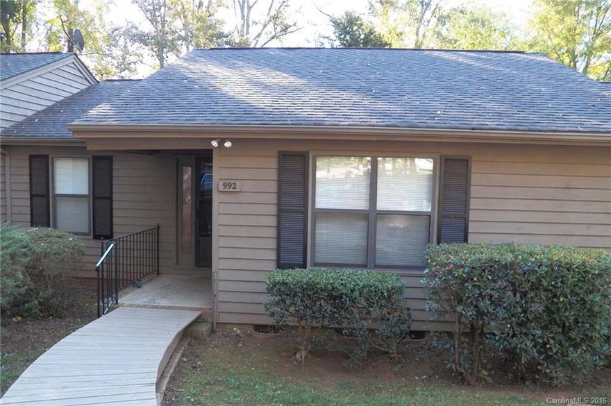 Freshly painted interior!  New carpet.  New laminate wood flooring in both bedrooms. Open floor plan.  Wood burning fireplace in Great Room.  Deck overlooks wooded view.  All appliances remain (as is, no problems known).  Storage room.  Ready to move in!!