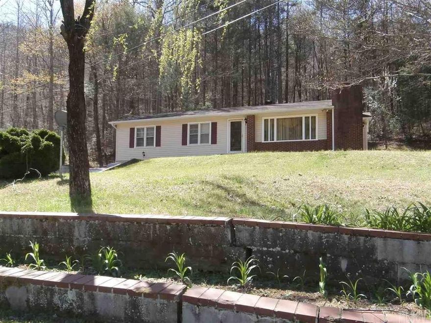 Priced very well... home has over 1400 square feet, basement, small screened utility porch in the back, and a small path down to the stream on the property. There are two acres and it is partially wooded. The house is an older home that has new vinyl siding and the roof was replaced in 2015. The living room and dining room has hardwood floors, tongue and groove paneling, built ins and a fireplace, vinyl flooring in the kitchen and hall bath, carpet in the three bedrooms. Cute as can be!