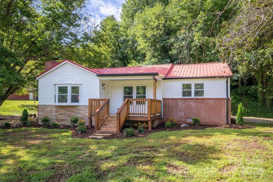 Adorable remodeled 3 bed/2 bath home with 6 ACRES! Located close to Lake James and Downtown Marion, this home offers an open concept floor plan and easy 1-level living. Recent remodel includes windows, HVAC, water heater, plumbing, electrical, sheetrock, paint, well pump, septic system, light/plumbing fixtures, carport roof, and more. Stylish design and colors throughout with new LVP flooring. You will love the kitchen boasting brand-new cabinets, granite counters, SS appliances, and island. Both full baths have also received a full remodel. Outside, enjoy the detached carport with workshop (has power), new covered front deck, and pasture with partial fencing. Mostly level land and NO CITY TAXES!