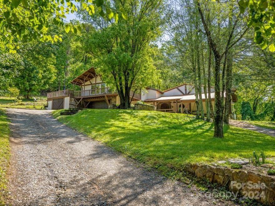 Stunning French Normandy Tudor home, gorgeous views of pastures & mountains, overlooking convergence of North and South Mills Rivers, creating a special location for your home. First time on the market in 30 years, with 4+ acres, spacious floor plan, rich in artisan details, custom cabinetry, handmade doors, hand forged copper and ironwork, heated stone floors and spacious Chef’s kitchen with 60” Lacanche French Range + Commercial Refrigerator, indoor/outdoor dining, screened porch, balconies, indoor sauna & hot tub, exterior stone walls, open level area perfect for chef’s garden, storage barn, gentle green pastures + RIVER ACCESS just outside your door. Home extensively renovated 10 years ago.  In the heart of peaceful Mills River with hiking, biking, horse riding trails, world class fly fishing, numerous restaurants, breweries, climbing gym, yoga studio and bike park minutes away. 1 year warranty, rate buy down & first right of refusal for adjacent pasture, beach & barn-home.