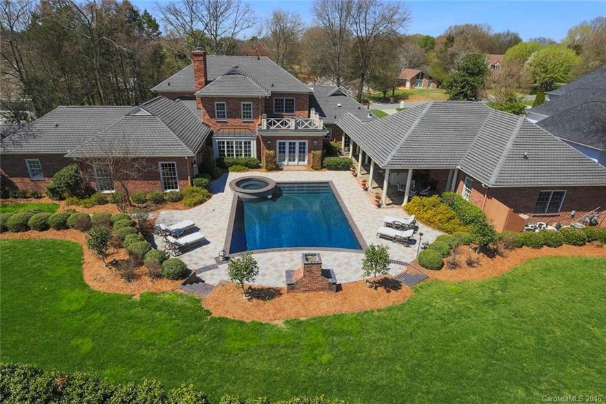 Golfer's paradise in the heart of Charlotte. Visit this chic estate boasting an expansive outdoor living area featuring pool, spa tub, covered bar, fireplace, grill and cabana or guest cottage suitable for many uses. Inviting French doors throughout the back open to bring the outdoors in, or vice versa! Four-car garage plus a separate golf cart garage en-suite to the master office, which gives you direct cart access to the North Course of popular Carmel Country Club. Smart home AV and security.