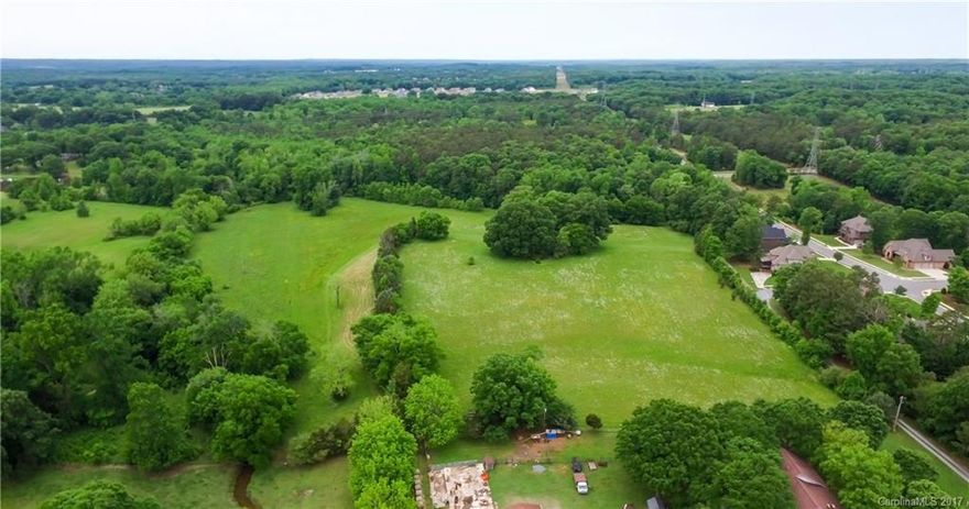 Breathtaking rolling hills and wooded elevated land perfect to build your dream house. Developer could subdivide acreage into 6-8 lots. 7 of 21 acres are in the flood plain.  Outbuildings as is.