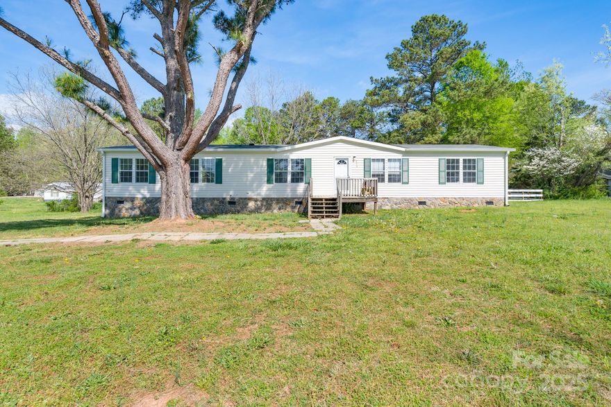 Back on Market!!Buyer could not get the financing.   Well located and Move In Read and loaded with space!!  Must see this Immaculately updated interior with New Kitchen cabinets and granite! countertops! Nestled on a serene 1-acre lot, this stunning 5-bedroom, 3-bathroom, one-level home offers the perfect balance of privacy and convenience. With a thoughtful split floor plan, this home provides ample space and comfort for the whole family. The Spacious kitchen features modern cabinetry and  two pantries, which makes it ideal for cooking and entertaining. Freshly painted walls and brand-new flooring flow throughout the home, creating a bright and inviting atmosphere. Step outside to enjoy the newly constructed oversized back deck and fully fenced backyard, perfect for outdoor gatherings or simply relaxing in the peaceful, rural setting. Located just minutes away from local amenities, this home combines country living with easy access to everything you need