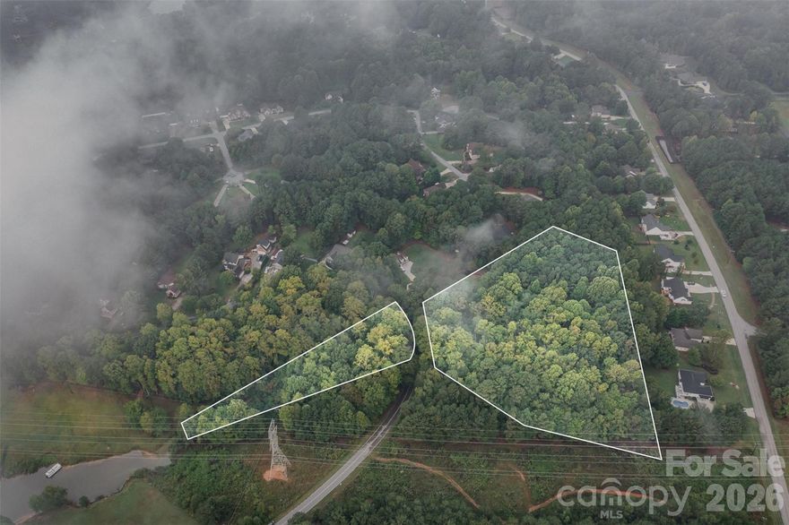 Build your dream house on this beautiful 4.3 acre combined lots that boasts lots of trees for privacy along with part of the lot that crosses the road with access to Lake Norman.  Bring your kayak or paddleboard to paddle along the lake or launch your boat from the private boat launch area that offers ample parking for you to enjoy a refreshing day on the lake. This community offers a private beach area with picnic tables, chairs, basketball nets and a gazebo.  Duke Energy has a powerline easement on the far right side of the property, diagram is attached. There is no boat dock permitted with this property per Duke Energy due to the shoreline classification, but don't worry, the community has a private boat launch area for all residents to use.