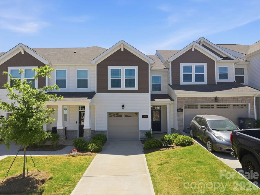 Welcome to this beautifully appointed townhome where comfort, style, and low maintenance living come together effortlessly. The home makes a welcoming first impression from the moment you arrive. Step inside to a thoughtfully designed foyer featuring a built in niche with shelving and an outlet, offering a perfect place for everyday essentials, whether it is a soft glow from a favorite lamp or a convenient spot to keep devices charged and ready as you head out the door. From there, the home opens into a spacious living room that feels both inviting and connected, flowing seamlessly into the kitchen and dining area, an ideal setting for everything from quiet evenings to gathering with friends and family. At the heart of the home, the kitchen is as beautiful as it is functional. Modern gray craftsman style cabinetry, quartz countertops, and a timeless subway tile backsplash set the tone. While the large center island with pendant lighting invites conversation, casual meals, and lingering moments. The sink overlooks the rear yard, offering a peaceful backdrop to your daily routine. Just off the kitchen, the dining area, anchored by a lovely accent wall, opens to the extended patio with privacy screens on each side. Backing to a common area, the outdoor space feels open and expansive, like a natural extension of your home, perfect for morning coffee, evening unwinding, or weekend get togethers. Upstairs, the primary suite offers a true retreat, overlooking the serene rear yard and designed for rest and relaxation. The ensuite bath features a double vanity, upgraded tile flooring, and an expanded tiled shower with a bench seat and transom window that brings in soft, natural light. A spacious walk in closet completes the suite. Two additional bedrooms provide flexibility for guests, work from home needs, or growing households, while the hall bath with double vanity and the conveniently located upstairs laundry room make daily living that much easier. Thoughtful touches like a walk-in linen closet and upgraded open stair railing enhance both function and the light, airy feel throughout. The attached one car garage is a flexible space currently used as a home gym, ready to adapt to your lifestyle. This townhome is ideally located just moments from Lake Wylie, McDowell Nature Preserve, and Rivergate Shopping Center so get ready to enjoy easy access to outdoor recreation, dining, and everyday conveniences. Move right in and start enjoying a carefree lifestyle just in time for summer.