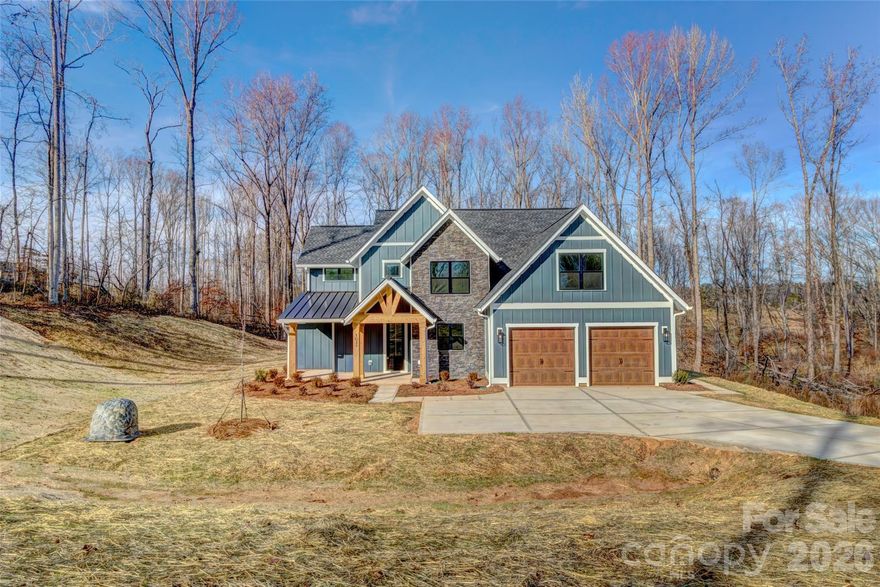 Welcome to country living at its finest in the Bennington Estates community. This brand-new River Birch plan by Oak and Willow Builders is a custom 1.5-story masterpiece, perfectly blending modern luxury with rustic charm through elegant wood and stone accents.

Designed for effortless living, this home features a highly desirable primary suite on the main floor, providing a private retreat with ultimate convenience. The heart of the home is a bright, open-concept great room that flows seamlessly into the well-appointed kitchen. You’ll love entertaining with a large center island, sleek, solid-surface countertops, and a stylish tile backsplash.

The living space extends outdoors to a stunning back porch featuring a vaulted wooden ceiling—the perfect spot to enjoy your expansive 1.89-acre lot. Located in rural Bessemer City, this property offers the rare freedom of a non-HOA neighborhood and includes a 10-year builder’s warranty for total peace of mind.