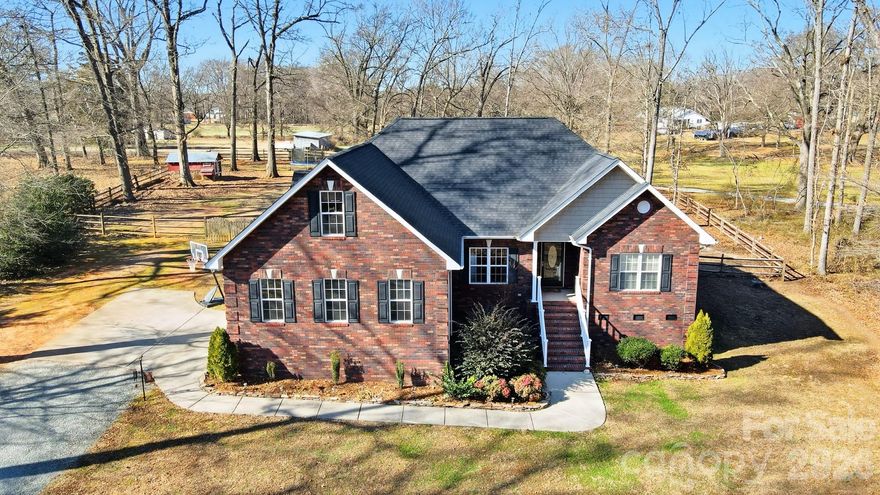 Wow—This stunning, custom full-brick home sits on nearly an acre in a prime Union County location with quick access to Hwy 601 and I-485. Start this tour with a long driveway and expansive front yard welcome you to this picture-perfect property surrounded by mature trees.
Step onto the covered front porch and inside you'll find with upgrades galore starting with gorgeous flooring and an inviting open floor plan. The spacious living room features a tray ceiling, stone fireplace, abundant natural light, and prewiring for surround sound—perfect for relaxing or entertaining. Plus Dining Room/Bonus Area/Office has upgraded moldings creating an elegant space for multiple uses. The custom chef’s kitchen offers granite counters, tiled backsplash, a corner double sink, large pantry, ample cabinetry, and a breakfast bar that opens to the dining area with beautiful backyard views. 
The oversized primary suite is a true retreat with a tray ceiling, large custom closet, and a bonus sitting/workout area with direct access to the back deck. The luxurious primary bath includes tile flooring, dual vanity, a jetted tub, and a stunning custom tiled shower with dual shower heads. This ideal split-bedroom layout places the primary suite on one side of the home and two additional large bedrooms plus a full bath on the other.
Upstairs offers endless possibilities—a huge bonus room, a second room currently used as an office, and a full bathroom. This upper level could easily function as a private apartment suite, home business space, guest quarters, or additional storage.
Your backyard oasis begins with a custom Trex deck overlooking serene views of the fenced yard and surrounding trees—providing enhanced privacy and a peaceful setting. The expansive outdoor space offers limitless potential for gardens, play areas, or future additions. Large, tall Crawlspace with lots of space for storage.
Additional highlights include top-rated Union County schools and a prime location close to shops, restaurants, local farm stands, and more. This custom home truly has it all—space, beauty, privacy, and convenience. Don’t miss it!