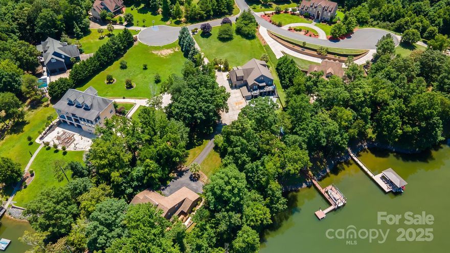 Experience luxury lakeside living on a stunning 1.41-acre waterfront estate with no HOA! Designed for comfort and entertaining, it's an outdoor paradise with 120 feet of shoreline and permitted private dock with boat lift, swim platform, and Sea Ray boat. Relax on the expansive upper deck, or enjoy fireside drinks on the lower deck closer to the shore. Gather round the firepit for s'mores or play pickleball on the sport court-sized patio, then have a relaxing soak in the hot tub.

Inside, you'll find a gourmet kitchen with granite countertops and luxury appliances. Upgrades include elegant hardwood floors on the main level, custom lighting, and similar upgrades throughout - see attachments for a full list. Upstairs, two bedrooms with en-suite baths and bed/bonus or playroom. On the lower level, you'll find a finished, walk-out basement with second kitchen, second primary bedroom, fireplace, exercise room, storage, and more.

You must see this home!