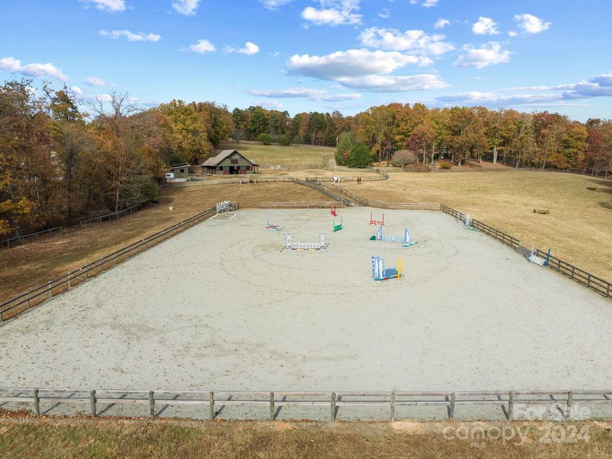 Your Dream Farm! Classic Tryon Horse Farm with direct access to the FETA trail system, 4 stall custom barn with Lucas stalls and doors, huge tack room w/ full bath and a large feed room, both with tons of built-in storage. Established pastures with quality fencing are level to slightly rolling - a true horseman's farm. The 120' x 215' riding arena and outbuildings set this property over all the rest! Quality 3,565 square feet,  3 BR 3.5 bath home, fabulous farmhouse kitchen, living room with stone fireplace that stretches up to a cathedral ceiling, cosy library/den, primary suite with two walk in closets and full bath. Extensive outdoor spaces, screened porch, multiple decks, and a pristine in-ground pool make it a perfect home for entertaining. This is one of the great horse farms in the Tryon area, hosting horse shows and clinics over the years - you can own a part of Tryon history! Multiple Use zoning offers lots of options for use including Bed & Breakfast.