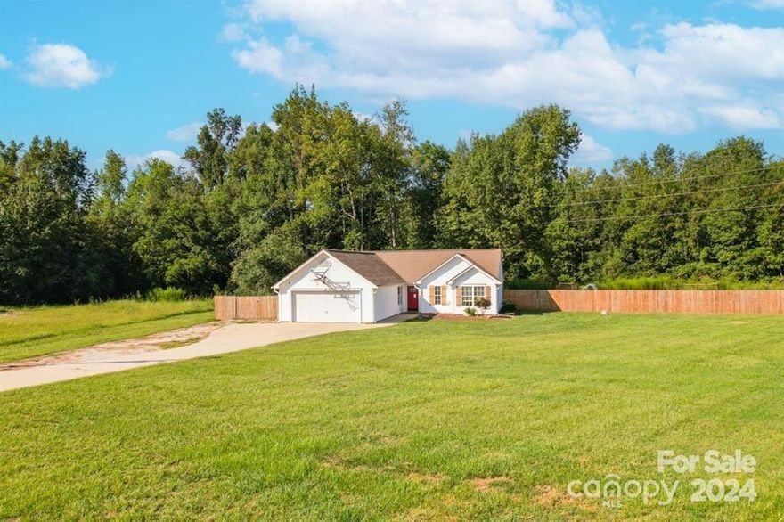 Welcome Home to this 3 bedroom, 2 bath ranch with attached garage. This house is well maintained and sits on 1.5 acres that is fenced in. This open floor offers a split bedroom layout making it ideal for your living needs. This particular plan makes very good use of space. There is a high, vaulted ceiling in the great room. Once inside there is a flex space which is perfect for a sitting room or office. Owner suite is roomy with a vaulted ceiling. The primary bath has a garden tub and separate shower. The fenced in back yard is sure to impress. There is pretty of space for outdoor entertaining and gathering. Make this one yours!