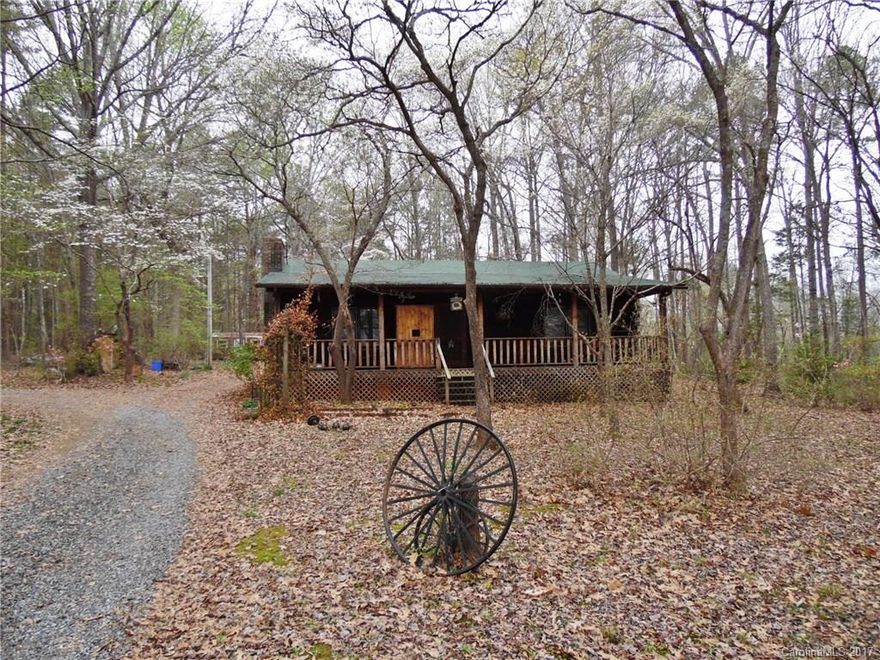 Loads of charm in this log cabin on over 4 acres of land.  Exterior features include front & rear porches that extend the length of the house, detached 2 car carport, storage building & lots of trees.  Great open floor plan makes it easy to entertain guests.
