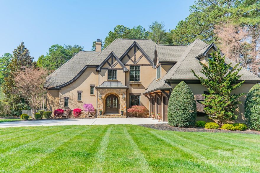This exquisite custom home, designed by Elite Design Group & built by Stonebridge, features an impressive Tudor-style exterior & a floor plan that is both functional and beautiful, seamlessly blending classic & modern, all on a large golf course lot with deeded boat slip #U7 just down the street. Entertain in the amazing outdoor living space with pool, spa, fire pit & covered terrace, all with fantastic golf views. The kitchen is a chef's delight with top-of-the-line appliances & every convenience at your fingertips. Each bedroom has its own ensuite bath & soaring tray ceilings are a repeat theme. A spacious office is on the 2nd level, as well as an entertaining space that includes a large bonus room, half bath & wet bar. The main laundry room, just off the drop zone with built-ins, is a spacious room that co-functions as a household computer niche with 2 built-in desks; there's a 2nd laundry upstairs. Great curb appeal, thoughtful design & elegant finishes make this a must-see home!