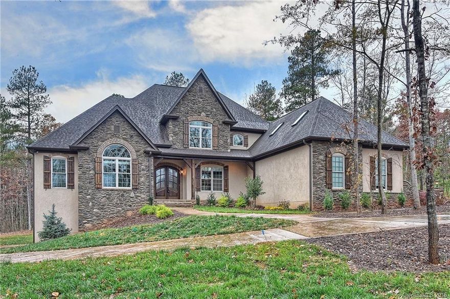 Stunning one of a kind custom built home nestled on a wooded lot in beautiful Lake Wylie. Lots of parking with a 4 car garage! Master and guest BR and office/BR on main level each with gorgeous baths.Lovely kitchen with copper sink opens to very transitional great room with beautiful angled wall with glass doors opening to fabulous screened porch. ABUNDANT storage throughout. Basement level offers BR, BTH, partial 2nd kitchen, finished flex space, rec room AND garage!MUST see this fabulous home!