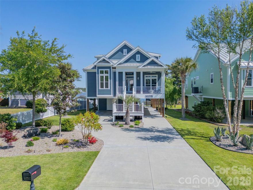 Immaculate and beautifully maintained, this one owner primary residence offers refined coastal living with breathtaking Intracoastal Waterway views. Never used as a rental, the home has been thoughtfully cared for and presents in exceptional condition. Being sold partially furnished, this property offers added convenience and immediate enjoyment. Step inside to discover soaring vaulted and coffered ceilings, complemented by custom light fixtures, creating an open, airy ambiance throughout the main living spaces. The well designed floor plan features 4 spacious bedrooms and 4 full bathrooms, including a luxurious primary suite on the first floor with a spa-inspired bath, complete with a garden tub, walk-in shower, and dual vanities. The heart of the home is perfect for both relaxing and entertaining, with a seamless flow between the living area, dining space, and well-appointed kitchen featuring distinctive Curava recycled glass countertops. Large windows. professionally tinted and enhanced with hurricane resistant film, bring in natural light while adding efficiency and peace of mind, all while showcasing the serene waterfront and marsh views. Upstairs, additional bedrooms and a generous loft area provide ample space for guests or a secondary living area, along with access to elevated outdoor spaces offering unmatched vistas of the Intracoastal Waterway. An elevator shaft is already in place, offering the option for convenient future installation. Outside, enjoy the coastal lifestyle to the fullest with multiple porches and a convenient outdoor shower, ideal after a day on the water. This premium piling home combines quality construction, thoughtful upgrades, and an unbeatable waterfront setting. A rare opportunity to own a pristine waterfront retreat that truly embodies the best of island living.