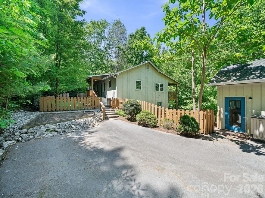 Beautiful mountain retreat nestled in the highly sought-after Swiss Pine Lake community in Spruce Pine, NC! This charming 2BR/3BA home offers a private wooded setting with a clean, nicely maintained front and side yard, plus a wooden fenced area perfect for pets and outdoor enjoyment. Step inside to a warm and inviting atmosphere featuring spacious living areas, gorgeous hardwood floors, and a stunning rock wood-burning fireplace on the main level. Two covered back porches provide the perfect space to relax and enjoy the peaceful mountain surroundings year-round and seamlessly blend indoor and outdoor living. The lower-level basement creates exceptional flexibility with its own exterior entrance, bedroom, full bath, living area, kitchenette/bar, and entertainment space - ideal for guests, multi-generational living, or potential long-term rental opportunities. A single-car garage, built in 2014, also offers valuable additional storage, workspace, and parking. Conveniently located within walking distance to Swiss Pine Lake and less than 5 minutes from Grassy Creek Golf Course, shopping, dining, and local amenities. Whether you are searching for a full-time residence, mountain getaway, or investment opportunity, this move-in ready home is full of potential and waiting for your personal touches! One of the best values on the market right now. The home actually features 3 bedrooms, but the septic system is only permitted for 2 bedrooms.