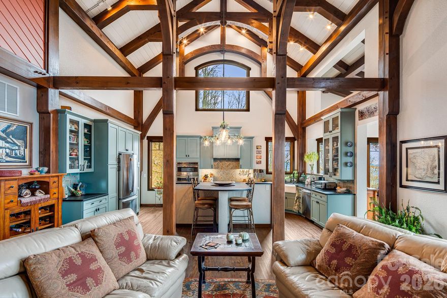 Perched at a rare 4,000-foot elevation and bordering 39,000 acres of Nantahala National Forest, 2223 Scarlet Ridge is a masterfully crafted mountaintop estate where architecture, engineering, and nature exist in perfect harmony. Designed to capture sweeping long-range views while remaining naturally protected from extreme weather, the home offers cooler summer temperatures, dramatic cloud inversions below, and exceptional privacy.
This handcrafted timber-frame residence showcases cathedral ceilings, exposed beams, and seamless indoor-outdoor living that reflects both refined craftsmanship and deep respect for the surrounding landscape. Built to endure, the home features superior construction including a reinforced concrete foundation, Structural Insulated Panel walls, fiber-cement siding, high-performance windows, and advanced systems designed specifically for high-elevation living. Modern comforts include a three-zone dual-fuel HVAC system with energy recovery ventilation, whole-house generator, instant hot water, pristine private well water, and a high-efficiency cast-iron wood-burning stove. Set on 17.72 private acres with trails, open meadow, and direct access to protected wilderness, the land offers unmatched connection to nature. From expansive terraces to forest paths and sweeping 40+ mile views, this is a mountain retreat as intelligent as it is breathtaking.This property is a must see to appreciate all it has to offer.