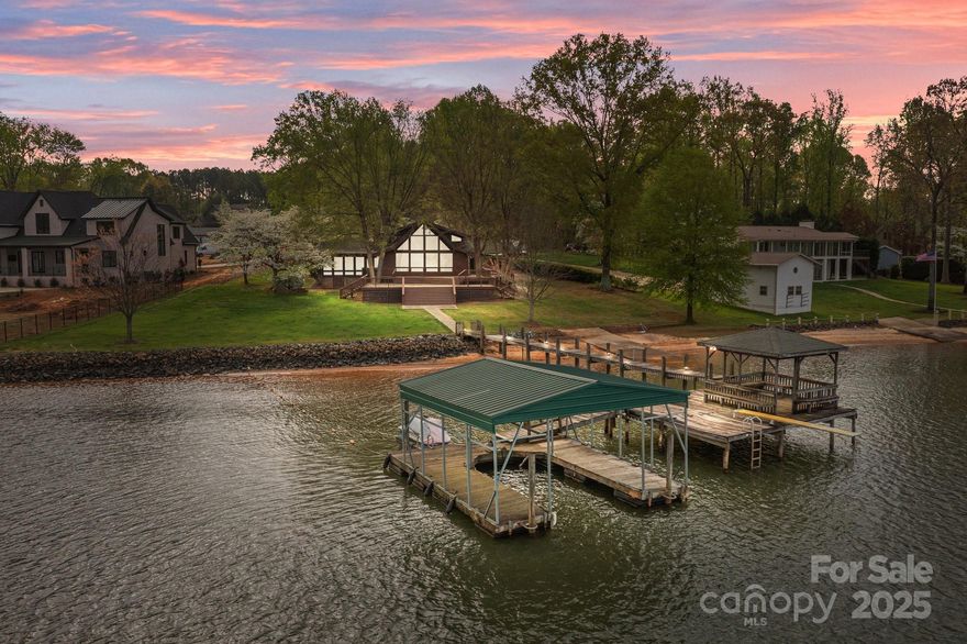 Captivating Lake Norman views and beautiful sunsets await you! Situated on a generous .73 acre lot with 192 feet of shoreline, a private beach and deeded dock, this waterfront retreat awaits. Main level features include floor to ceiling windows, galley style kitchen with updated stainless steel appliances, and stunning hardwood floors. Great room features floor to ceiling, two story windows giving the perfect views of the Lake Norman sunset. Enclosed 4 seasons room, primary bedroom and bath and a second bedroom and full bath round off the main level.  Ascend the open stairs to find a loft area with lake views and two additional bedrooms and full bath.  Step outside to a view that is unparalleled!  A massive, multi-level deck awaits and leads to a large level yard, beach access and dock.  The possibilities for waterfront enjoyment are endless. This home would be the perfect lake retreat, investment opportunity, or primary home!  No HOA, quick access to I-77 and Hwy. 150.