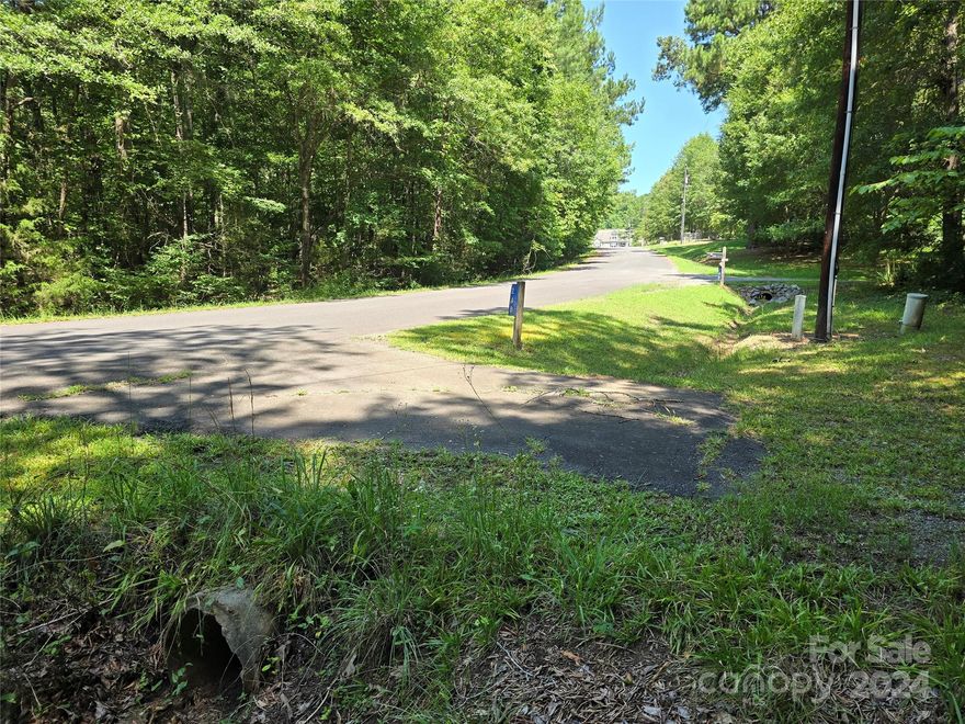 Could this serene wooded lot in a well-established neighborhood be the ideal location for your future home?  This property offers coveted privacy with its deep layout and dense tree coverage, enhanced by the  small creek that runs along the property. Some remnants of a previous residence remain including a well pump house, a probable septic tank, meter base for former underground electrical service, and another unknown structure. (see photos) Please note that the functionality of former utilities are not guaranteed to be usable. Act now to seize this opportunity to live at this convenient location with no city taxes to pay.