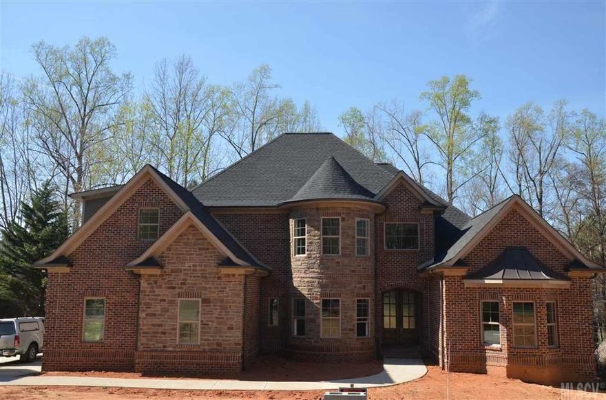 Executive style home in Moores Ferry. Lakefront community with clubhouse and pool. Main level features open floor plan, custom kitchen with professional grade appliances (cabinets will go to the ceiling), keeping room with fireplace, great room with 2 story ceilings/fireplace, dining room, half bath, laundry, master suite with master bath and large walk-in closet, and guest room with bath. 2nd level features two bedrooms, 2 full baths and large bonus room. High ceilings, hardwood floors, stone tile and large bedrooms. Upgrades galore. Large covered patio. Truly a must see!