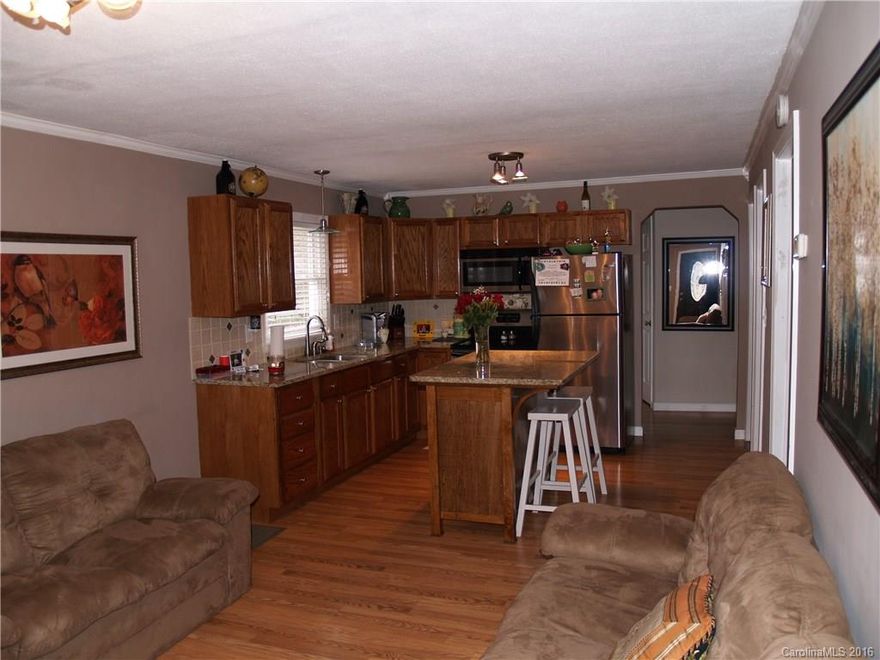 This home will not disappoint you. Tastefully updated with Ceramic tile, pre-finished Wood floor coverings, a beautiful range and refrigerator and a convenient laundry area just off the kitchen.  Prepare your meals in the spacious kitchen area while keeping an eye on the family activities. Lots of cooking space, cabinets, lighting and neutral colors make this home a must see. The two bedrooms are large with ample storage and large closets. Shed for storage on the premise.