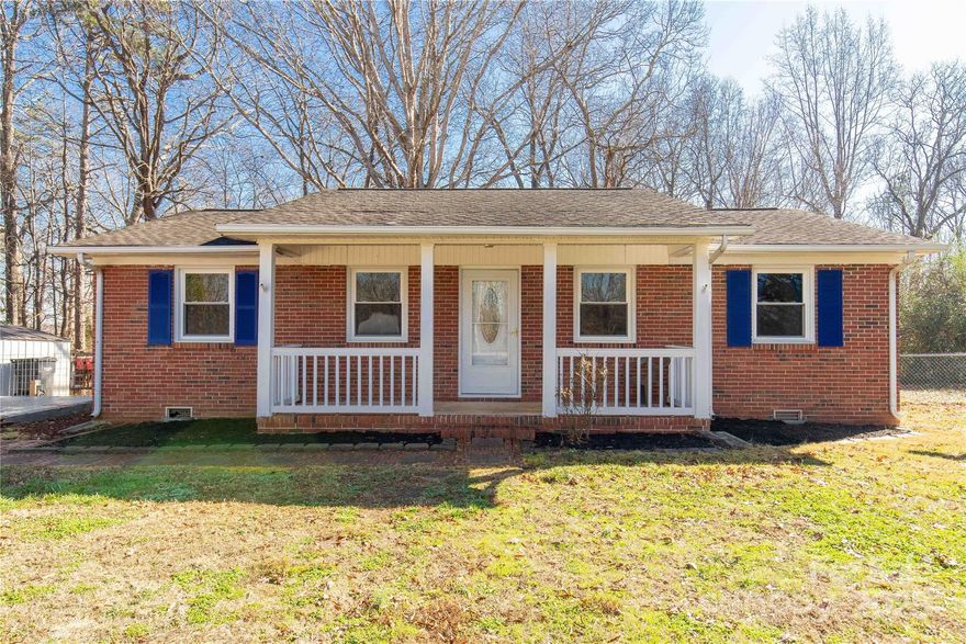 Tucked beneath mature hardwood trees, this charming brick ranch offers peaceful country living with the convenience and affordability you are looking for. Situated on a large, wooded lot, the setting provides privacy, shade, and room to enjoy the outdoors year-round. Inside, the home features 2 bedrooms and 2 full bathrooms, including a spacious primary suite with plenty of room to unwind. Step outside to enjoy a large back deck overlooking the fully fenced backyard, perfect for pets, gatherings, or quiet evenings surrounded by nature. A covered front porch adds to the home’s inviting curb appeal and is the ideal spot for morning coffee or sunset views. A large concrete pad offers excellent flexibility—ready for a future detached garage, carport, or expanded patio space. With Clover School District and low York County property taxes, this home delivers exceptional value for anyone seeking comfort, space, and a true country feel without sacrificing practicality. Affordable, peaceful, and full of potential—this is one you don’t want to miss.