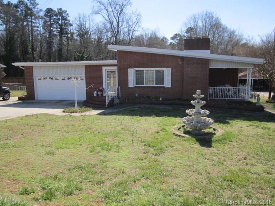 Home in the city w/ 1.45 acres. Beautiful hardwood floors in the foyer, living/dining room. Fireplace with gas logs. Laminate flooring in kitchen/den area. Loads of cabinet space in kitchen. Two bedrooms have doors leading out to large covered deck with ramp leading to the pool area. New windows. Attached 2-car garage & detached 2-car garage w/ work area and with adjoining 2 room efficiency apartment. Industrial TPO roof. 24x24 inground octagon pool. Convenient to hospital,shopping,restaurants