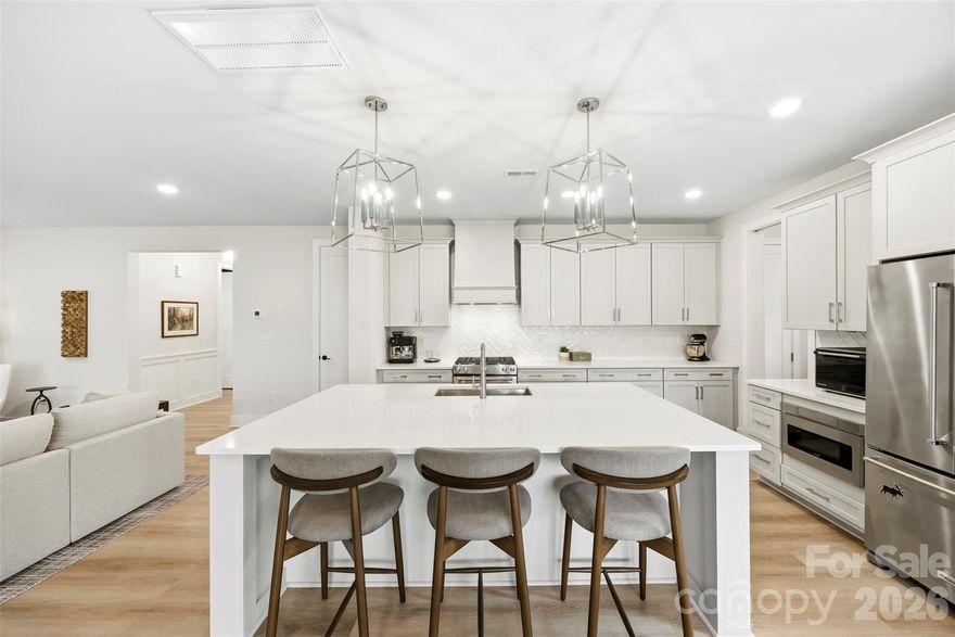 Better Than New Construction — No Wait, No Extra Investment Required! MUST SEE Premium Lot with Fully Completed Outdoor Living in desirable Matthews Ridge Reserve.

Welcome to 2723 Ritz Lane — where modern luxury meets timeless design in an exclusive community by Kinger Homes. With only 31 thoughtfully crafted single-family homes, this intimate neighborhood offers a rare blend of privacy, upscale living, and convenience.

Why wait for new construction when this home already has it ALL? Meticulous owners have invested significantly to elevate this home beyond builder grade — saving you time, money, and hassle.

Upgrades & Improvements Include:

Expansive 19'x16 'screened-in porch
Extended paver patio for seamless indoor-outdoor living
Fully fenced yard
Professional landscaping
Epoxy-coated garage floors
Custom closet systems

Step inside to a completely carpet-free interior featuring sought-after wide plank flooring (9x20) throughout, delivering a clean, modern, and cohesive feel. The open-concept layout is ideal for both everyday living and entertaining.

The designer kitchen is a standout with a custom vent hood, oversized island, walk-in pantry, and ample prep space — flowing effortlessly into the spacious family room. A sleek linear electric fireplace with modern slat trim creates a stunning focal point.

The main level includes a guest bedroom and full bath with walk-in shower, perfect for multi-generational living or visitors. Upstairs, enjoy ensuite bedrooms for ultimate privacy, plus a versatile bonus room/flex space ideal for a home office, media room, or playroom.

Step outside and experience true indoor-outdoor living — relax or entertain year-round on your screened porch and extended patio overlooking the beautifully finished backyard.

Located just minutes from shopping, dining, and entertainment, this home offers both luxury and lifestyle in one of Matthews’ most desirable newer communities.

Move-in ready. Upgraded. Better than new construction.