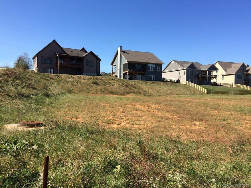 Corner lot in highly desirable location, centrally located between Asheville & Hendersonville, minutes to Airport Rd. amenities. Community with pool, clubhouse, stocked lake and sidewalks. Public water, sewer 7 gas.