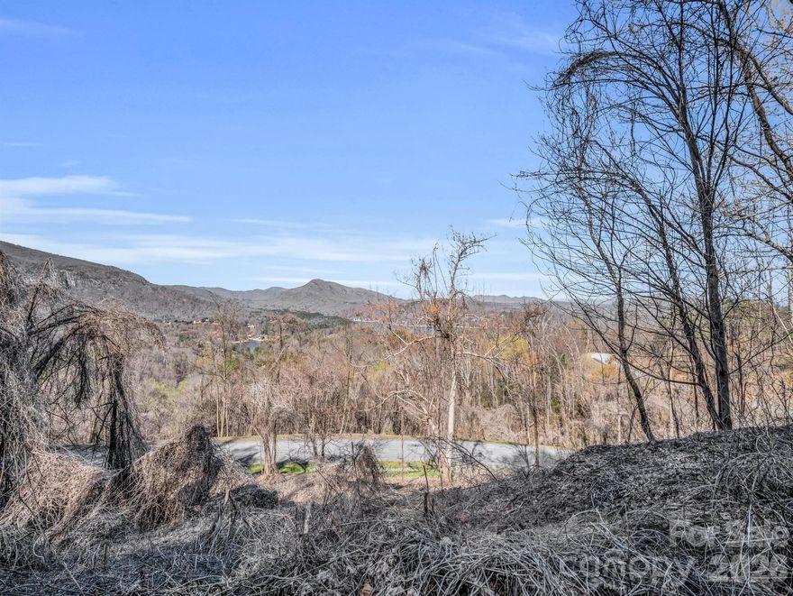 An extraordinary homesite is available in the prestigious Highlands of Lake Lure gated community. This previously cleared lot features a "pre-cut driveway" and offers unparalleled, sweeping views! Imagine watching the sun set over the glistening lake and the majestic mountains on the horizon, while the distant mountain communities come alive with twinkling lights against the night sky. This property is designed for those who seek awe-inspiring mountain vistas without compromising on accessibility. Just a short drive away from grocery stores, the Lake Lure area, the Tryon International Equestrian Center and more! City water hookup available and underground utilities. Reach out to arrange a personal viewing (*gated) and marvel at the captivating mountain views and the beauty of Lake Lure that people come from all over to see!