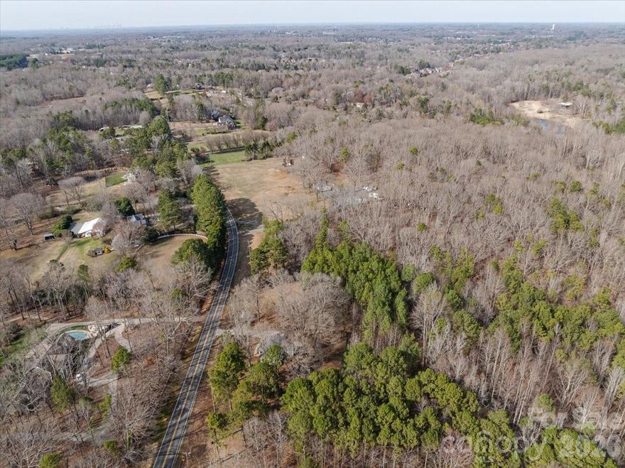 Thinking about building your dream home?  Want to subdivide and sell 4 lots separately?  Live in this adorable home and sell the remaining lots?  Live in this gem while you are building your forever home?  Surrounded by million + dollar homes on smaller lots -  Just over 5 acres that can easily be subdivided to accommodate any of your goals - Location... location... location - Right in the heart of Weddington and surrounded by arguable some of the best schools in the state - Fully updated 2 bedroom / 2 bathroom home is currently rented (lease ends 9/2026) so the property is making money for you while you are working out your dream plans - Storage shed and fencing makes a great set up for storage while developing - Hardwood floors throughout and wood burning fireplace - Primary suite with private en-suite & walk in closet -  Generous secondary bedroom - Large utility/laundry room offers great storage - Well laid out floorplan is a wonderful place to call home surrounded by 5 acres to enjoy some breathing room - Minutes to shopping / dining and entertainment make this the perfect location - Level lot is perfect to enjoy or develop in the future - Soil scientist has already evaluated the lot and offered some perk suggestions - Call anytime for questions