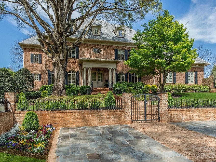 Amazing Foxcroft location! Spectacular full brick home had extensive renovation in 2010 & additional updates in 2020 & 2021. Interior features a grand foyer w/ winding staircase, library, large formal areas & open floorplan including great room w/ stone fireplace & glass temp controlled wine wall. Additional sunroom w/ fireplace features walls of windows and 2 sets of accordion style doors that open to separate terraces to enjoy the outdoors. Gourmet kitchen oversized island, high end appliances opens to breakfast room w/ vaulted ceilings. Primary suite on main w/luxury bath (steam shower & heated floor), 2 large closets, & laundry rm. 4 ensuite bedrooms on second floor w/ game rm & theater. 3rd floor office has full bath & could be Guest Suite. Heated saltwater pool w/spa, pool bath & sauna. Private professionally landscaped rear lot & courtyard w/ gated entry for security. Detached climate controlled exercise rm could also be golf cart storage. Generator & Synthetic Slate Roof.