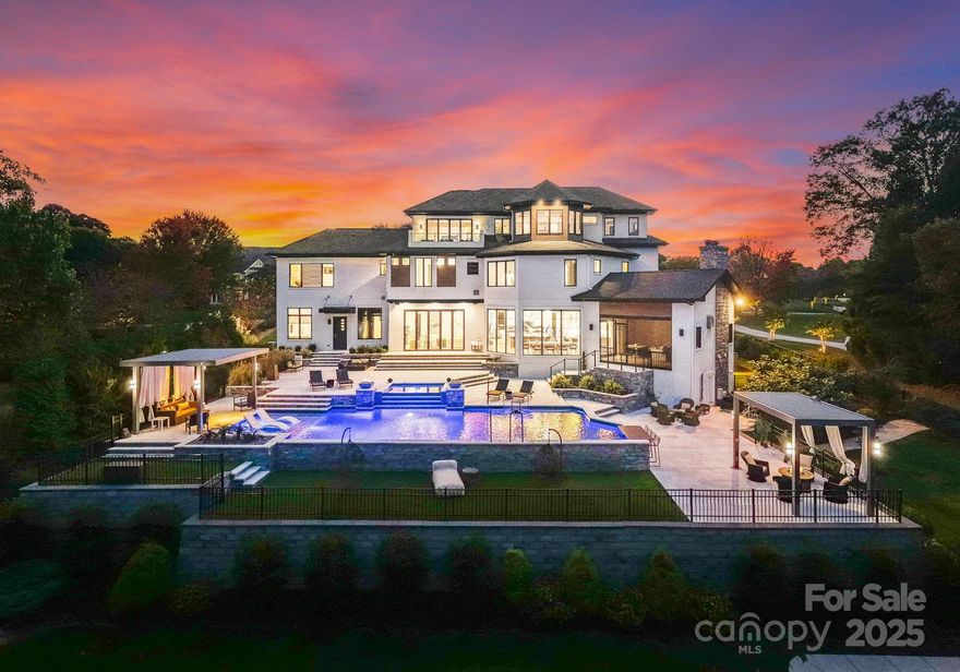 A one-of-a-kind modern masterpiece on Lake Norman. Crafted for those who live boldly, move purposefully, and expect nothing less than excellence. Designed with precision and presence, this 2020 custom-built estate rests on nearly an acre in the prestigious community of The Point. Spanning nearly 9,000 square feet across three elevator-served levels, this architectural icon delivers the perfect balance of privacy, performance, and panoramic lake views.
From the moment you enter, the energy shifts. A 30-foot handmade chandelier cascades through a sculptural staircase, setting the tone for a residence that blends scale with style. Walls of glass flood the interiors with natural light, while folding doors and soaring ceilings create seamless indoor–outdoor living. Every element, from coffered ceilings to designer lighting is intentional, crafted to amplify light, space, and the surrounding water.

The chef’s kitchen is both a showpiece and a workhorse, anchored by dual Cambria Bentley Quartz islands and finished with Zebrano-inspired cabinetry, a hidden walk-in pantry, and professional-grade appliances. It’s a space designed to entertain, perform, and impress. The main level flows effortlessly between dining, lounge, and living spaces making this home ideal for hosting at scale or enjoying intimate moments in luxury.

Upstairs, the primary suite delivers serenity and sophistication with lake views, a spa-inspired bath, and a boutique dressing area. Secondary suites continue the elevated experience with refined materials, private baths, and thoughtfully designed layouts. The third floor extends the lifestyle with a lakefront balcony, media lounge, fitness retreat, and a full wet bar, offering the ultimate space to recharge or entertain.

Technology and design converge with state-of-the-art automation managing lighting, sound, climate, and security, all easily controlled from anywhere. Spray-foam insulation, tankless water systems, and energy-efficient components ensure this home performs as flawlessly as it looks.

Outside, the backyard transforms into a private resort. Natural stone surrounds a custom-designed pool and spa featuring a swim-up bar ledge, tanning shelf, fire features, and a curtain waterfall, all positioned to capture tranquil cove views. Multiple terraces, screened lounges, and alfresco dining areas make outdoor living a year-round experience. And just steps away, your deeded boat slip awaits.

Additional highlights include a four-car garage, whole-home security system, and professionally curated landscaping. Perfectly positioned within The Point, residents enjoy access to an extraordinary lifestyle, from the Greg Norman–designed Trump National Golf Club to tennis, fitness, spa services, fine dining, and lake recreation, all just minutes away by land or water.

Owned by someone who performs at the highest level, this residence reflects focus, discipline, and success. And now, the ball is in your court. Time to lace up and own a bold new chapter on the water. 134 Cape Cod Way isn’t just a home. It’s a legacy in motion, a rare opportunity to claim one of Lake Norman’s most iconic modern estates. 

Private showings by appointment only.